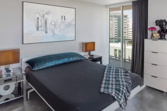 A bedroom with a bed and a window