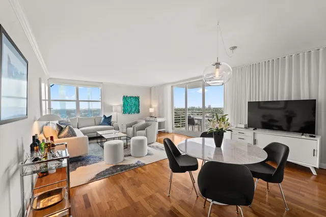 A living room with a table and chairs in it