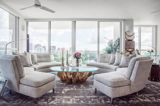 A living room with many chairs and couches